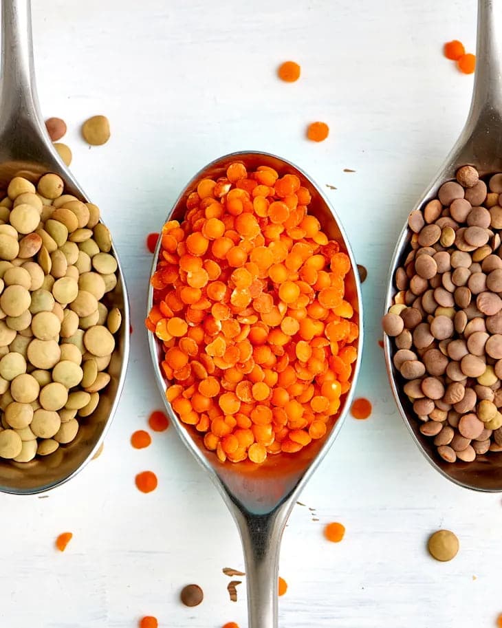 Red, brown, and green lentils side by side